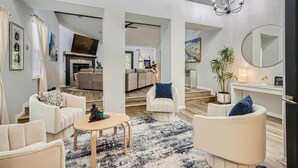 A spacious living room with a high ceiling, a fireplace, and a dining area. - The Casa Cantera by Six Flags, La Cantera, The Rim. 3Br Home with Pool & Cabana (San Antonio)