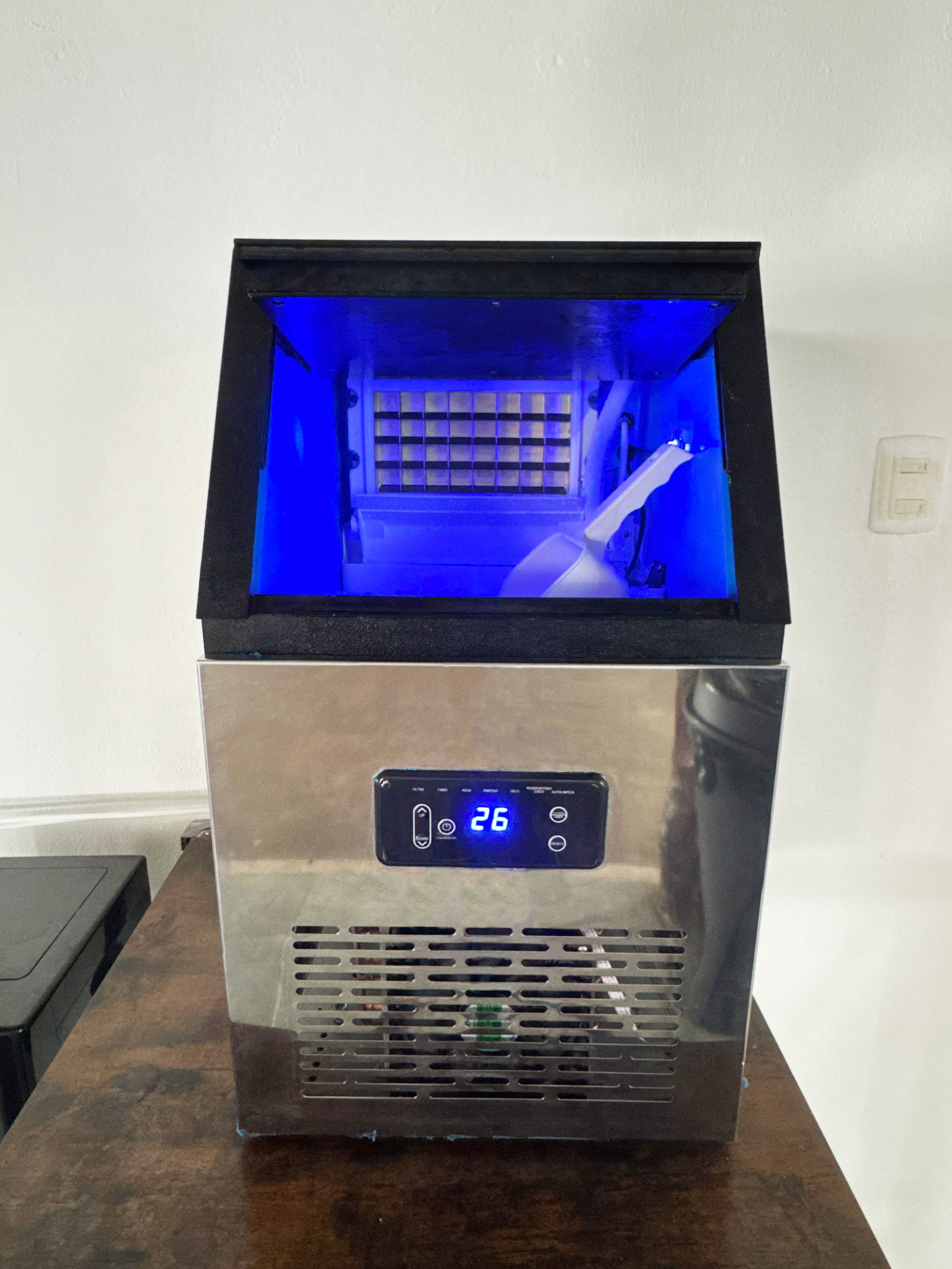 A stainless steel appliance with a digital display, a vented front panel, and a blue interior light.