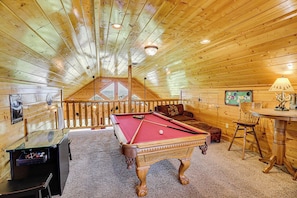 A cozy wooden room with a pool table, a sofa, and a small table with a lamp. - A Cozy Smoky Mountain Escape w/ Views (Sevierville)