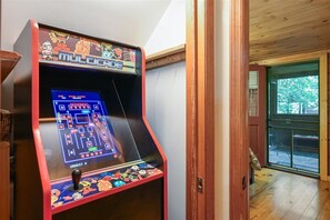 A video game arcade machine labeled 'MULTICADE' with a game interface, a joystick, and a colorful control panel. - Serene Cozy Cabin w/ Hot Tub & Games (Sevierville)