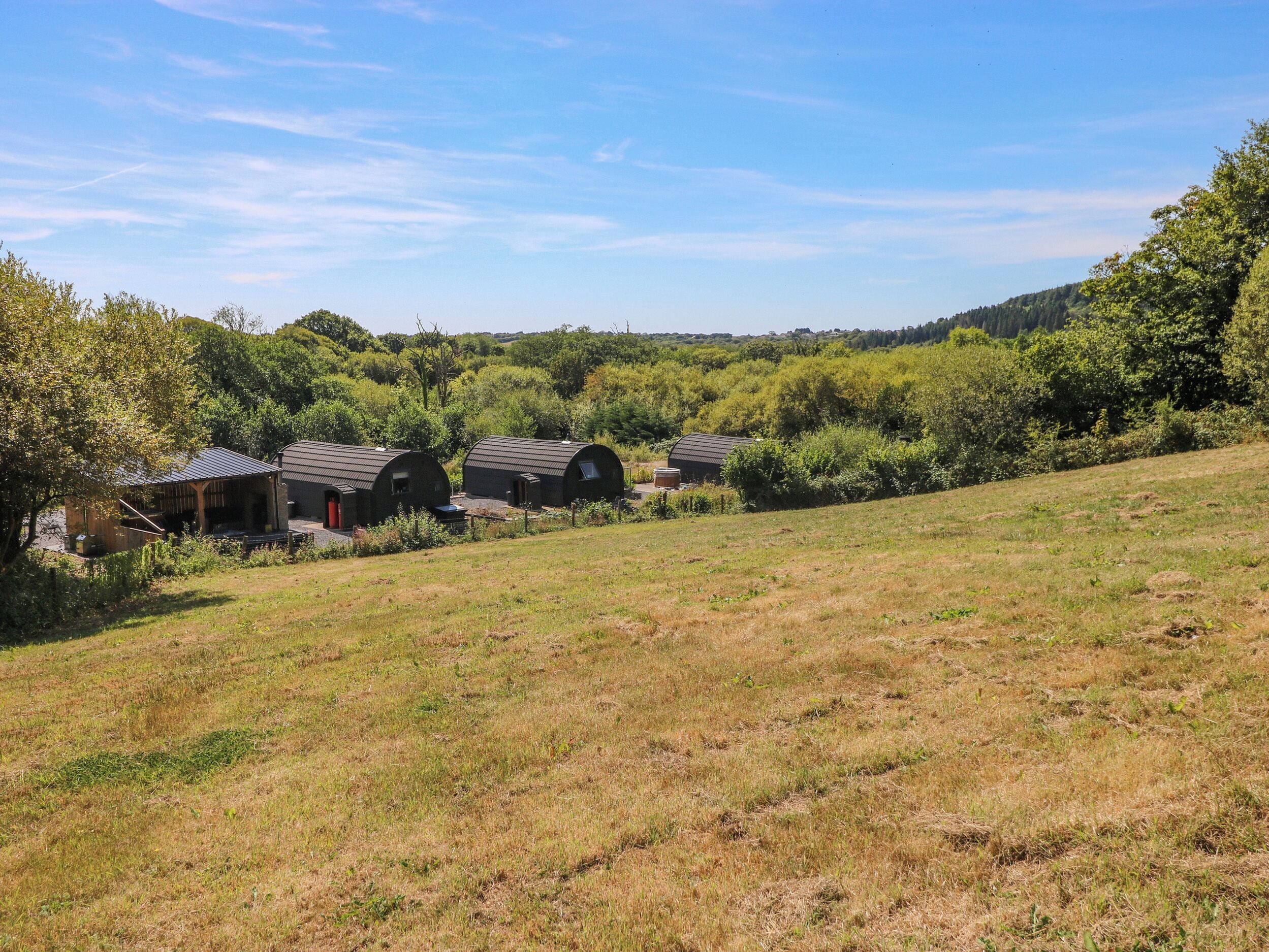 A rural setting with multiple barns and a grassy field.
