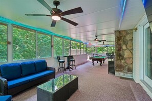 A spacious indoor area with a pool table, a sofa, and ceiling fans. - 4BR Home | Theater + Hot tub + Games + Fire Pit (Gatlinburg)