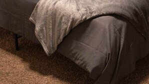 A bed with a wooden headboard, grey bedding, and a grey throw blanket. - Kipps Hill Haven B — Folsom Lake Escape (El Dorado Hills)