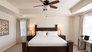 A bedroom with a bed, bedside tables, a desk with a laptop, a ceiling fan, and a window with curtains. - 5B4B in Parker w/ Game Room, Fenced Yard & Garage (Parker)