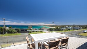 A balcony with a table and chairs overlooking a coastal view. - The Lookout Manyana, Ocean views to GreenIsland and over Manyana Beach (Manyana)