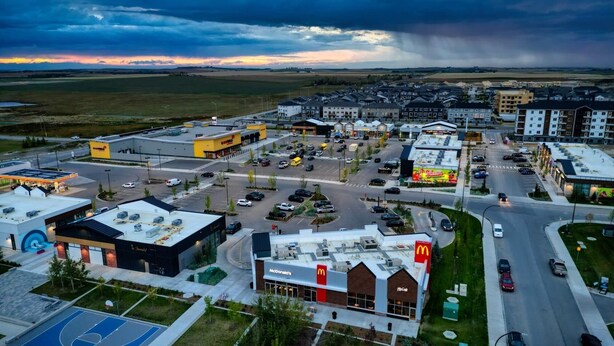 A commercial area with a McDonald's restaurant, a KFC, and a large parking lot. - Modern 1BR Private Suite Near Airport and Amazing Shopping!Free Netflix, Parking (Calgary)