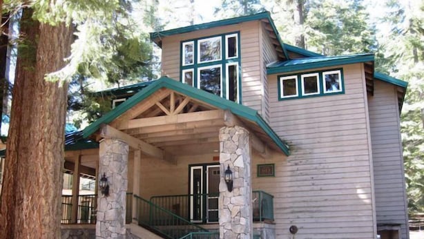 A lodge with a stone porch, wooden beams, and a green roof. - Droge-Yuklois, LACC in Lake Almanor, CA (Lake Almanor)