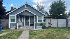 A single-story house with a gray exterior and a front porch. A sign above the door reads "Welcome." - Lakeside Retreat in Chester, CA (Chester)