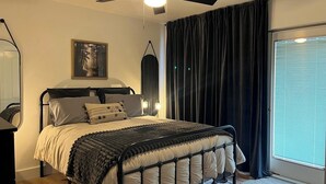 A bedroom with a bed, a ceiling fan, a window with curtains, and a painting on the wall. - Rice in Lake Almanor West, CA (Lake Almanor West)