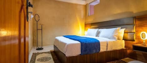 A bedroom with a wooden bed, a nightstand with a lamp, and a floor lamp.
