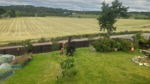 A rural landscape with a field, a road, and a fence. - Kick back and relax in this calm, stylish with views of beautiful Strathnairn. (Inverness)