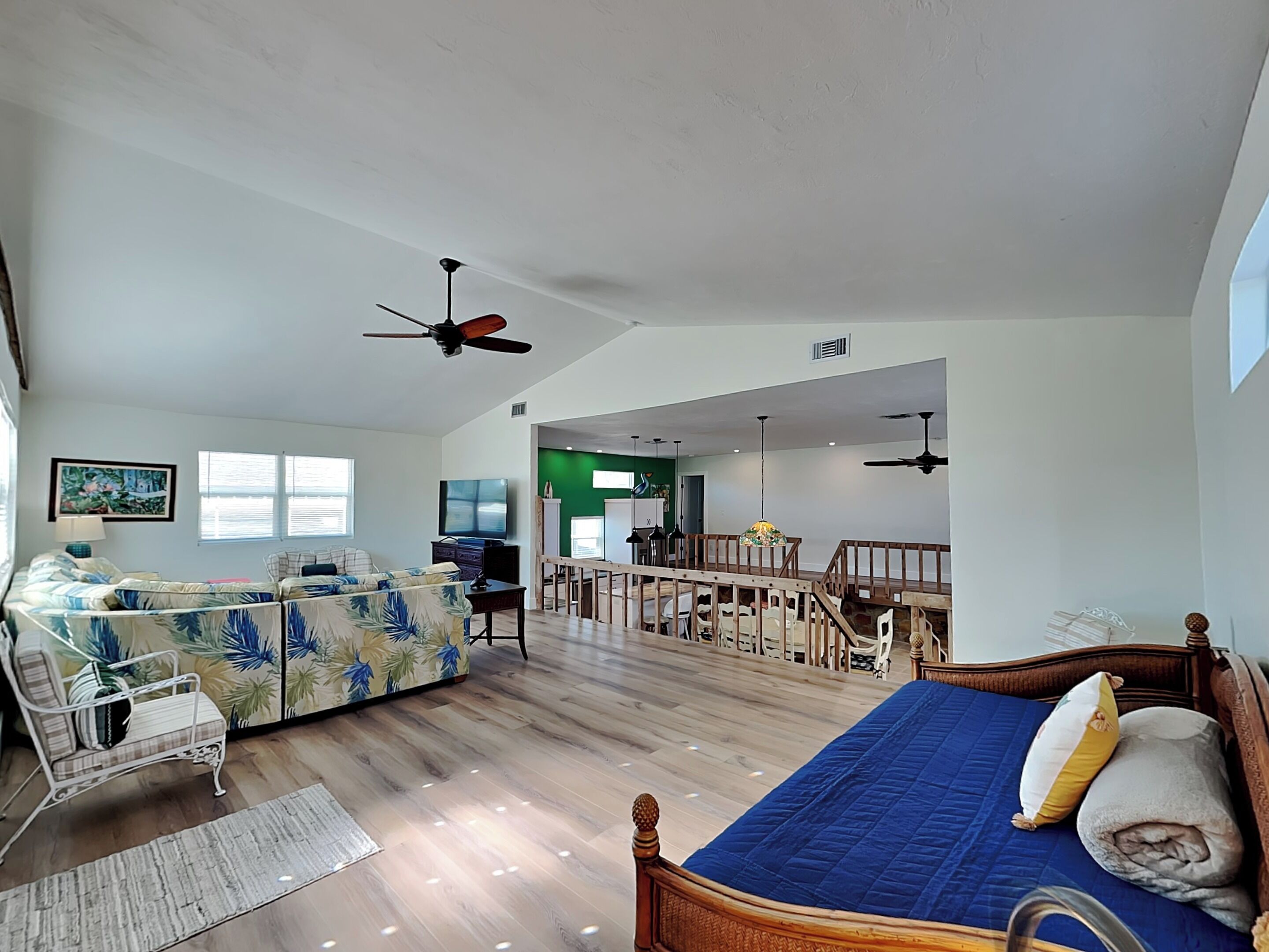 A spacious living area with a sofa, a bed, and a dining table.