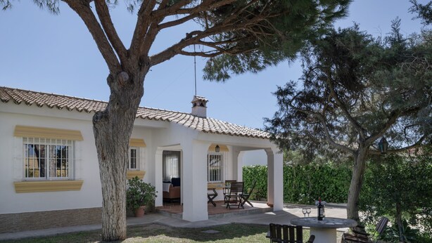 A house with a patio, a dining area, and a covered outdoor seating area. - Rural House 'Casas Pepe 2' with Private Terrace, Wi-Fi, and Air Conditioning (Los Caños de Meca)