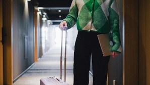 A person in a hotel hallway with a suitcase and a laptop. - Hotel Nuit by ilar (Bogotá)