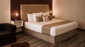 A modern bedroom with a large bed, a nightstand, a sofa, and a glass coffee table. - SED DE VALLE-VALLE DE GUADALUPE  (Valle de Guadalupe)