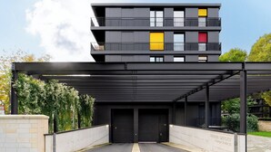 A modern multi-story building with a covered entrance and a sign indicating "MARINA GARDEN." - Gleam Homes Marina Garden Dresden (Dresden)