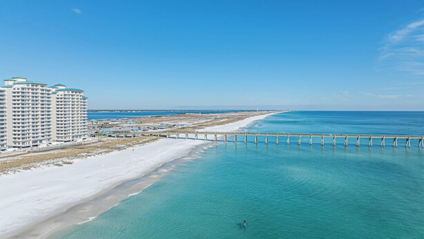 A coastal view with a beach, a pier, and a high-rise hotel. - Beach Haven: 6 Beds, Pet Friendly, 8miles to Beach (Mary Esther)