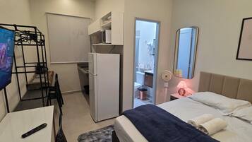 Standard Apartment, City View | Desk, laptop workspace, blackout drapes, soundproofing