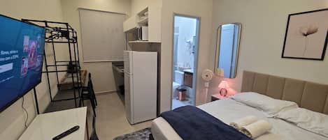 Standard Apartment, City View | Desk, laptop workspace, blackout drapes, soundproofing