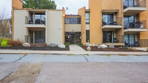 A modern apartment building with multiple balconies, a central entrance, and a landscaped front yard. - Adorable 1-bedroom condo 109 - Lava Hot Springs Resort a Romantic Getaway (Lava Hot Springs)