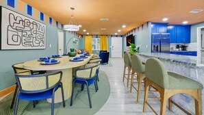A modern kitchen with blue cabinets, a marble countertop, and a built-in refrigerator. - Backyard Oasis • Pool •  Hot Tub • Putt Putt • Bar (Largo)