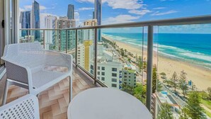 A balcony with a view of a beach and cityscape. - Luxury 2 Bedroom Ocean View Apartment in Surfers Paradise (Surfers Paradise)