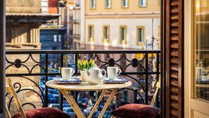 A balcony with a table set for two, featuring a vase of flowers, two cups, and a teapot. - Umberto 34 Collection (Naples)