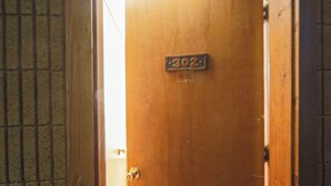 A wooden door with a metal plate displaying the number 302. - Adorable 1-bedroom condo - 201 Lava Hot Springs Resort (Lava Hot Springs)