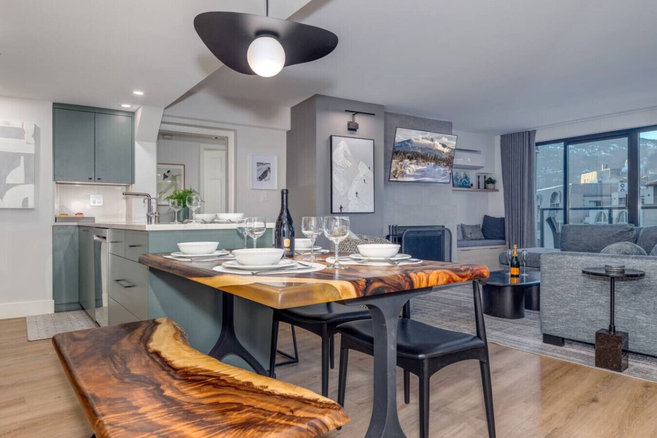 A modern apartment with a dining area, kitchen, and living space.