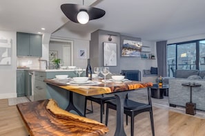 A modern apartment with a dining area, kitchen, and living space. - Best Location! Gorgeous & Spacious 2BD with Views (Whistler)