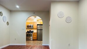 A kitchen with wooden cabinets, a microwave, stove, and refrigerator. - Spacious Camelback Retreat w/ Fireplace (Henryville)