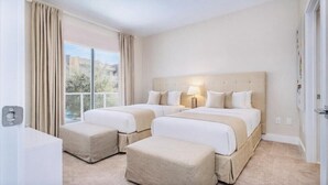 A hotel room with two beds, a large window, and a view of the city. - Beautiful Magic Village Townhome Minutes from Disney (Kissimmee)