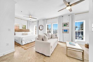 A spacious room with a bed, a sofa, a coffee table, and a ceiling fan. - Golden Hour Seacrest by Stay on 30a (Seacrest Beach)
