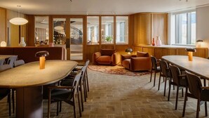 A modern interior with a large dining table, comfortable seating, and a view of the outside. - Canvas Wembley Arthur House (Wembley)