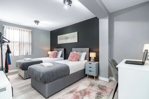 A modern bedroom with two beds, a desk, and a laptop. - Fairfax Close, Amesbury, Wiltshire, SP47ST, United Kingdom (Amesbury)