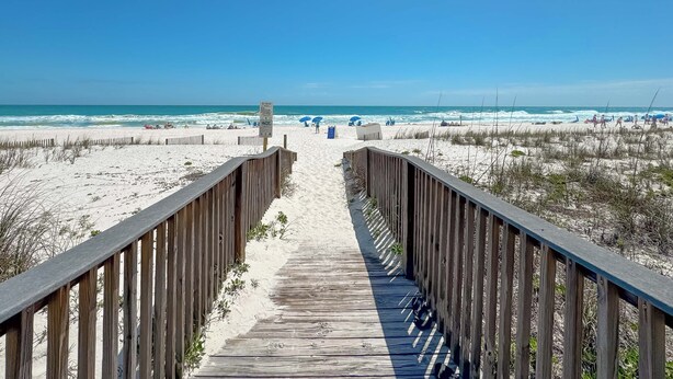 A wooden boardwalk leading to a beach with clear skies. - Dolphin Key 3C | Beachfront | Pool | Boat Slips | My Beach Getaways (Orange Beach)