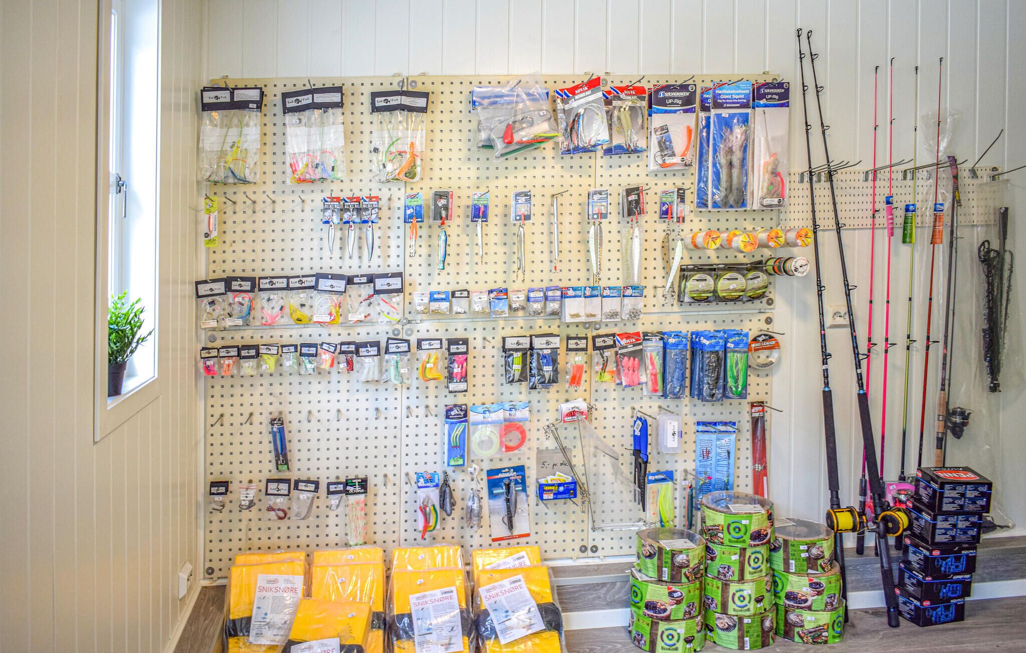 A fishing store with pegboards displaying fishing rods, lures, and tackle.