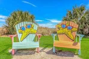 Two beach chairs with starfish designs and a clear blue sky. - Ocean Lakes 1586 (Myrtle Beach)