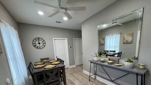 A dining area with a wooden table, chairs, and a ceiling fan. - 1 BEDROOM with code lock. SHARED SPACE . 30 day minimum stay.  (Arlington)