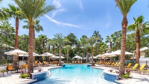 A swimming pool with lounge chairs and umbrellas, surrounded by palm trees. - Sleeps 14 | Bikes | Sunshine State of Mind | 30A | Pool | Beach Access (Inlet Beach)