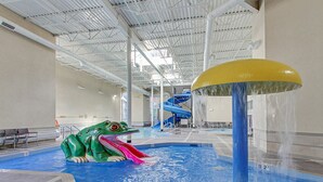 An indoor swimming pool with a water slide, a diving platform, and a large yellow dome structure. - Perfect Rockies Escape with Pool, Hot Tub and Gym (Canmore)