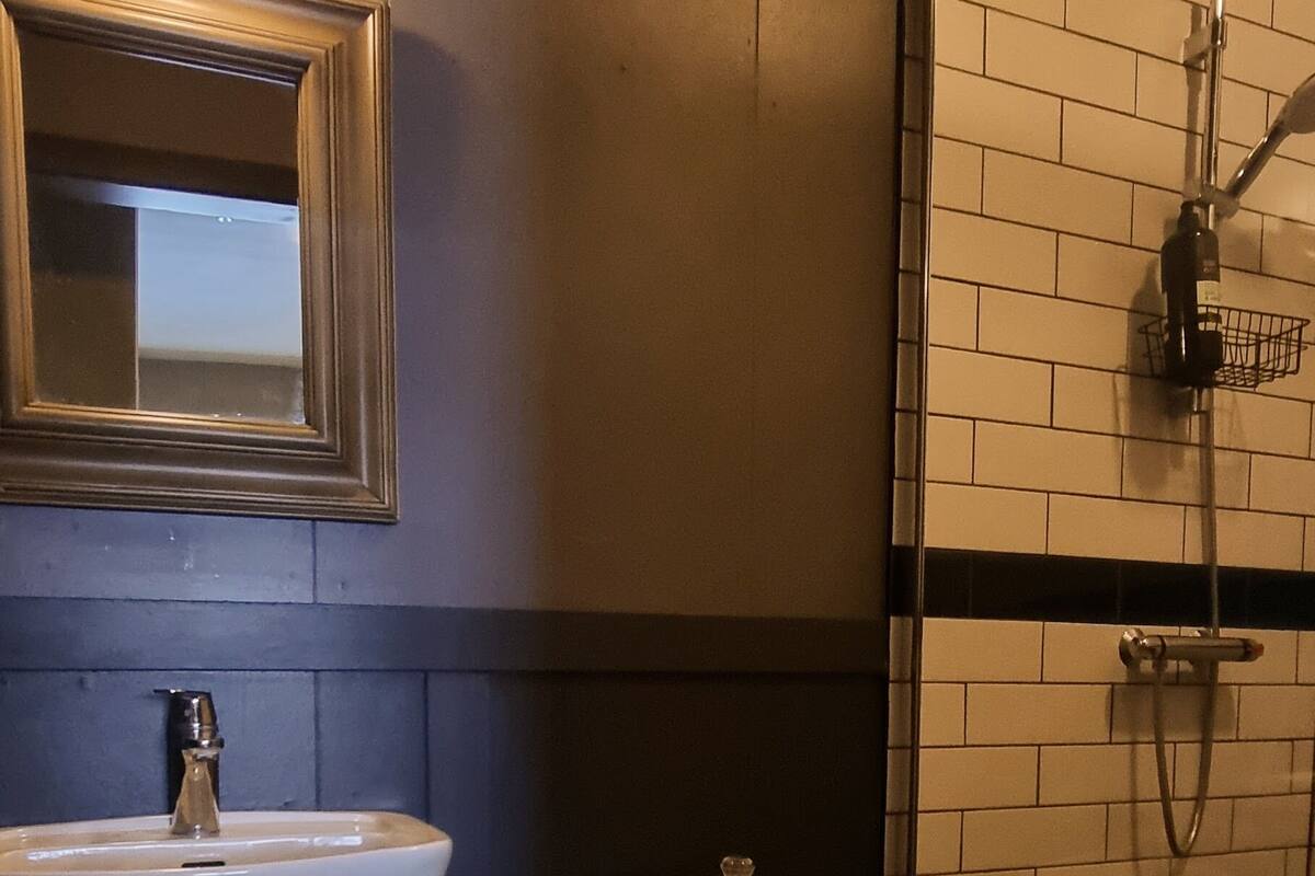 A bathroom with a sink, toilet, and shower.