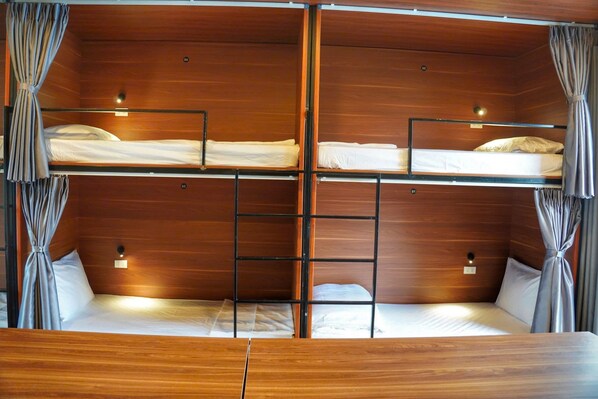 A bunk bed room with wooden walls, curtains, and bedside lamps. - The Luna Tam Coc Hostel - Bar & Pool (Nam Hoa Lu)