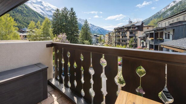 A balcony with a view of a mountain, buildings, and a clear sky. - Cham Sud Iris361 Near Aiguille du Midi | Balcony Views, Chamonix, France (Chamonix)