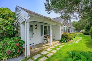 A single-story house with a front porch, a small dining table, and a chair. - Cloud 9 - Community Pool-Walk to beach-Private (Harwich Port)