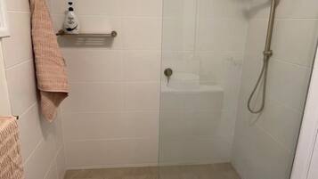 Shower, towels, soap, toilet paper