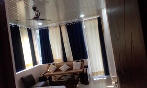 Deluxe Room | Living area | 32-inch flat-screen TV with cable channels - PHS KASAULI HILLS (Krishangarh)