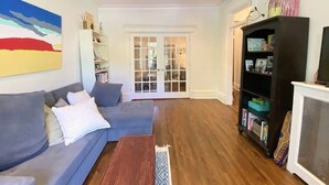 A living room with a grey sofa, a wooden coffee table, a bookshelf, and a fireplace. - 2-bedroom large impeccable apartment in fabulous Montréal. (Montréal)