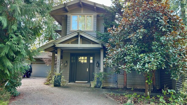A two-story house with a front porch, a driveway, and a mailbox. - Fern Hollow - unwind in this nature inspired suite in Edgemont Village. (North Vancouver)