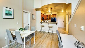 A compact kitchen with wooden cabinets, a built-in microwave, and a stainless steel refrigerator. - 4 Mi to Dtwn, Commuter-Friendly Apt in Tacoma (Tacoma)